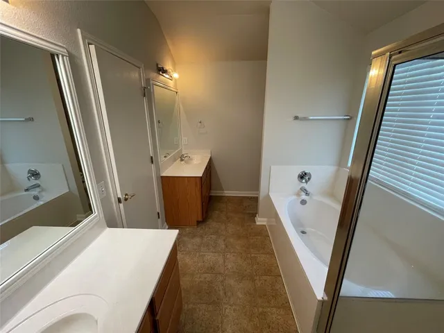 a bathroom with a sink a mirror and shower