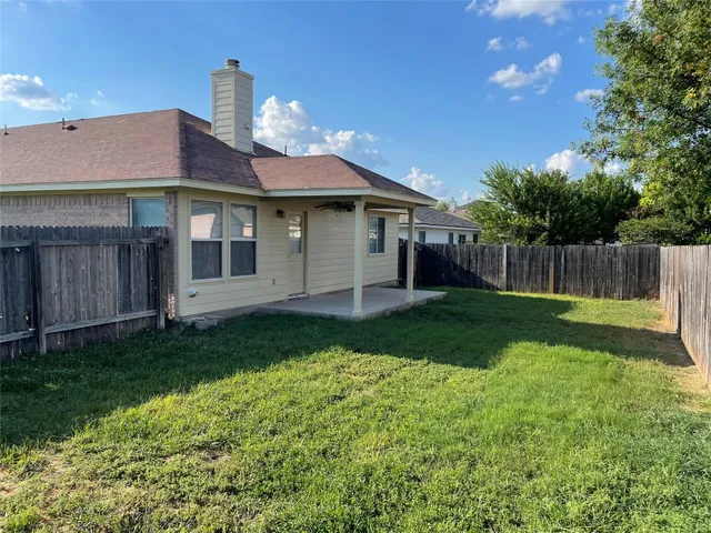 a front view of a house with a garden and yard