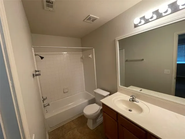 a bathroom with a sink toilet tub and shower