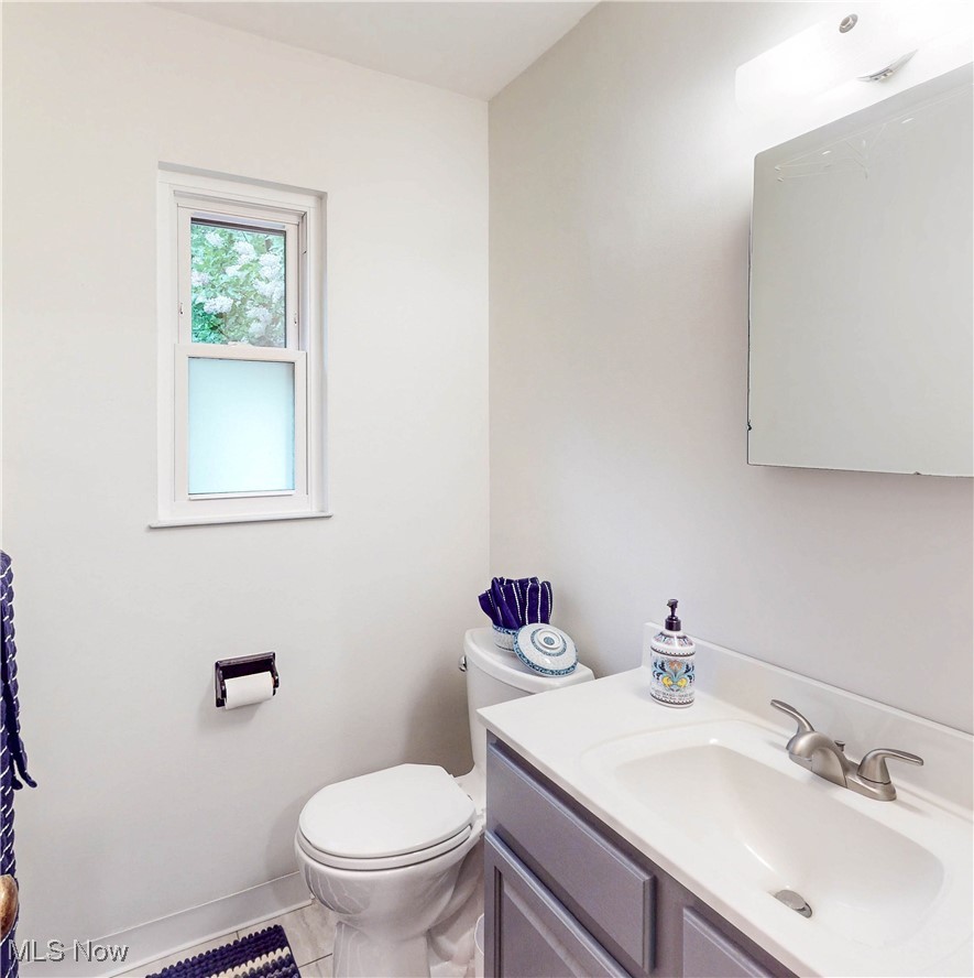 891 Sovereign Road Akron, OH 44303 - Photo 13 of 30 Bathroom featuring toilet, vanity, and baseboards