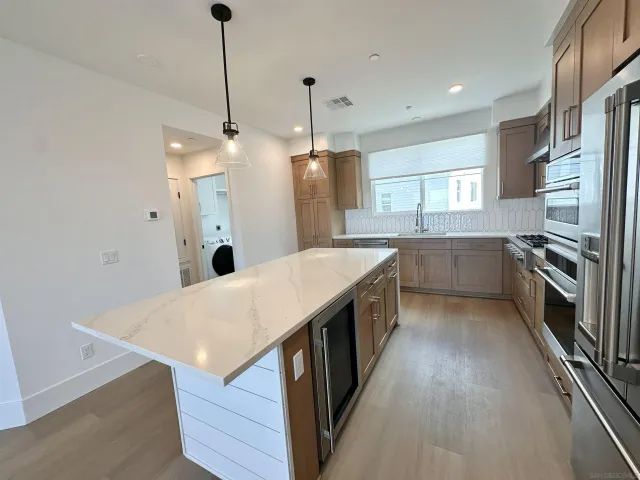 a kitchen with stainless steel appliances a refrigerator sink and cabinets