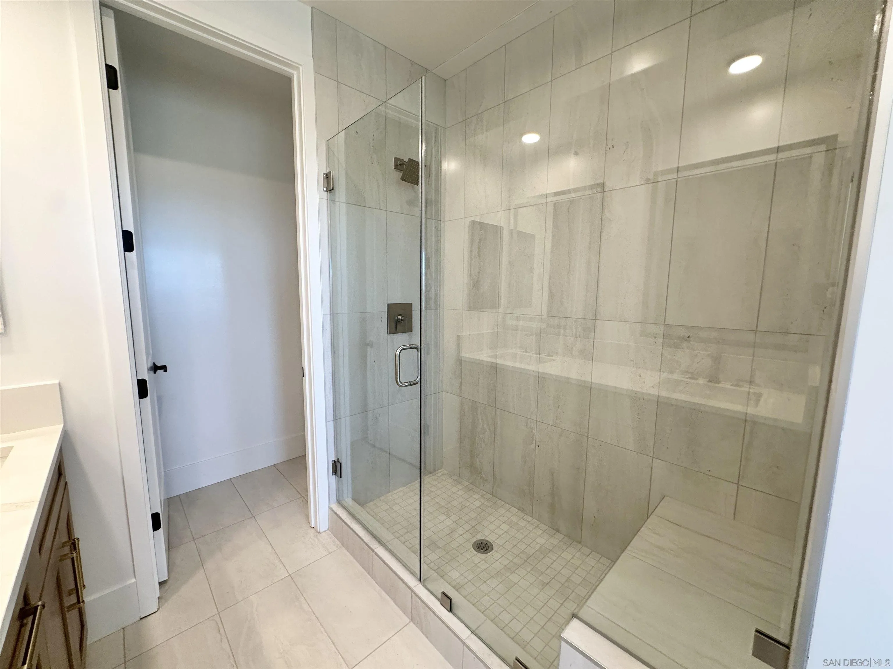 7290 Ponto Drive West, Unit 7132 Carlsbad, CA 92011 - Photo 29 of 44 a bathroom with a shower and a glass door