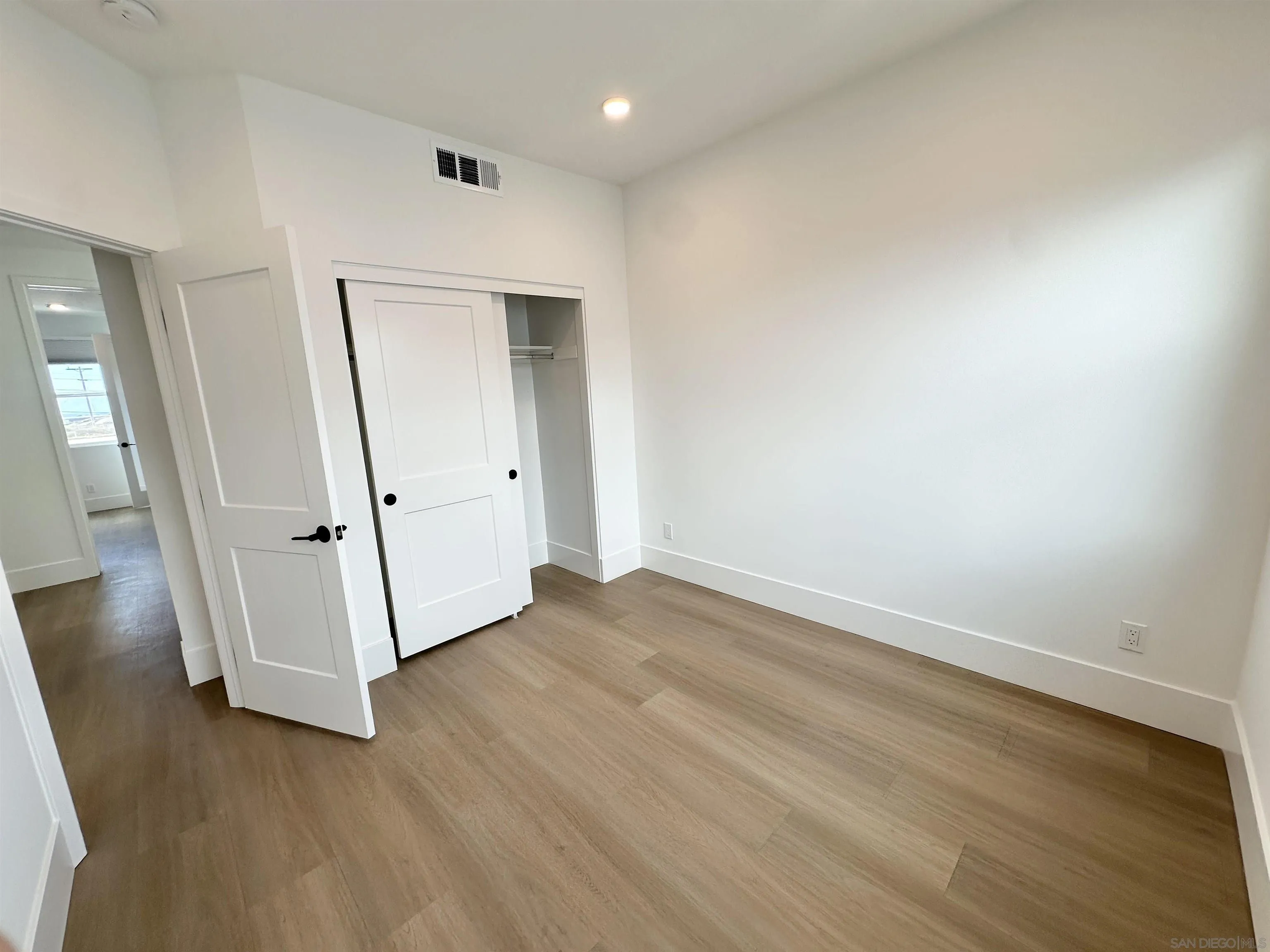 7290 Ponto Drive West, Unit 7132 Carlsbad, CA 92011 - Photo 35 of 44 wooden floor in an empty room with a window