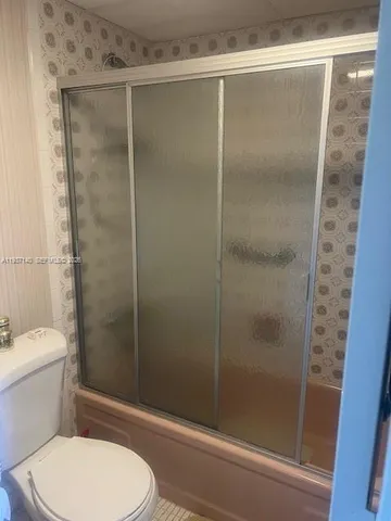 a spacious bedroom with bed and window