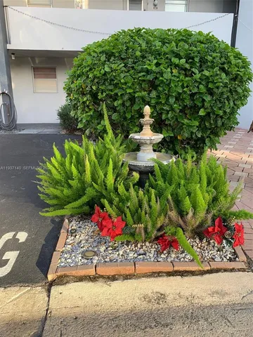 a bunch of flowers in front of the house