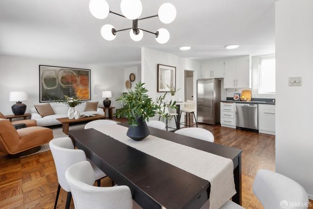 a view of a dining room with furniture and wooden floor