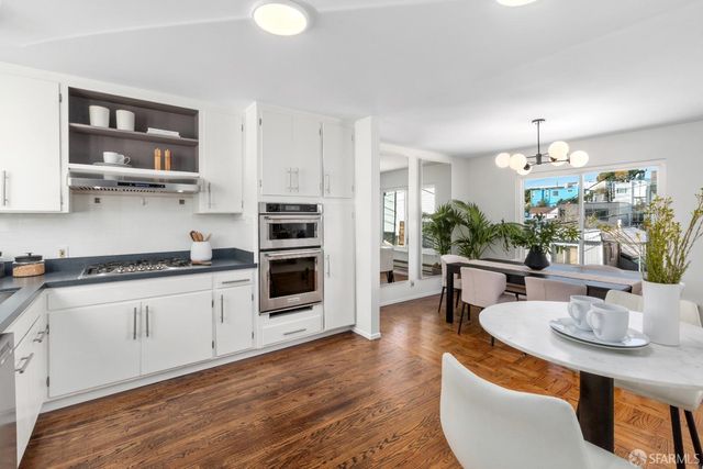 a view of a backyard with table and chairs