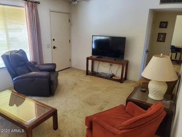 a kitchen with cabinets and chairs