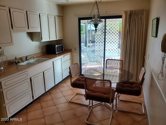 a kitchen with stainless steel appliances granite countertop a refrigerator a stove a sink and white cabinets