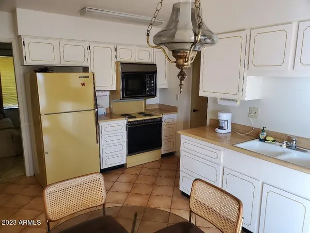 a kitchen with white cabinets and a sink