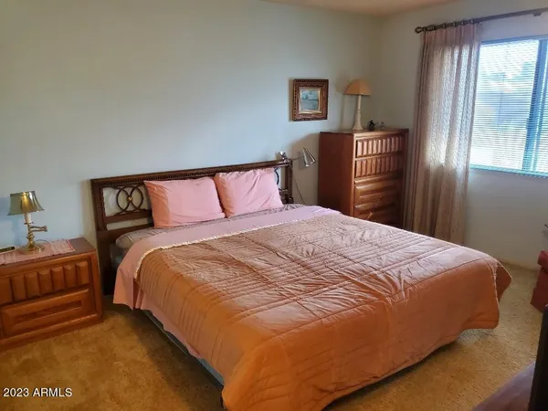 a bedroom with a bed and a chair