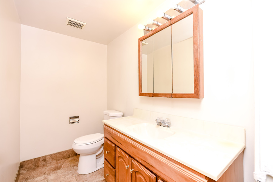 218 East Bailey Road, Unit A Naperville, IL 60565 - Photo 7 of 11 a bathroom with a sink a toilet and mirror