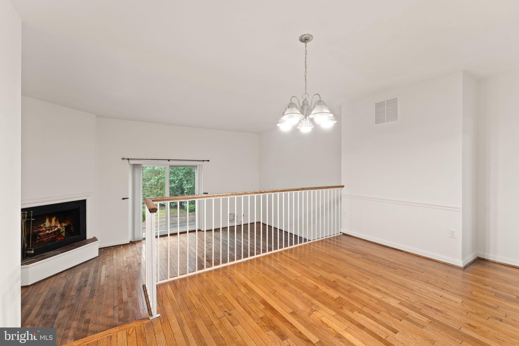 2212 Golf Course Drive Reston, VA 20191 - Photo 13 of 49 a view of a livingroom with wooden floor and a fireplace