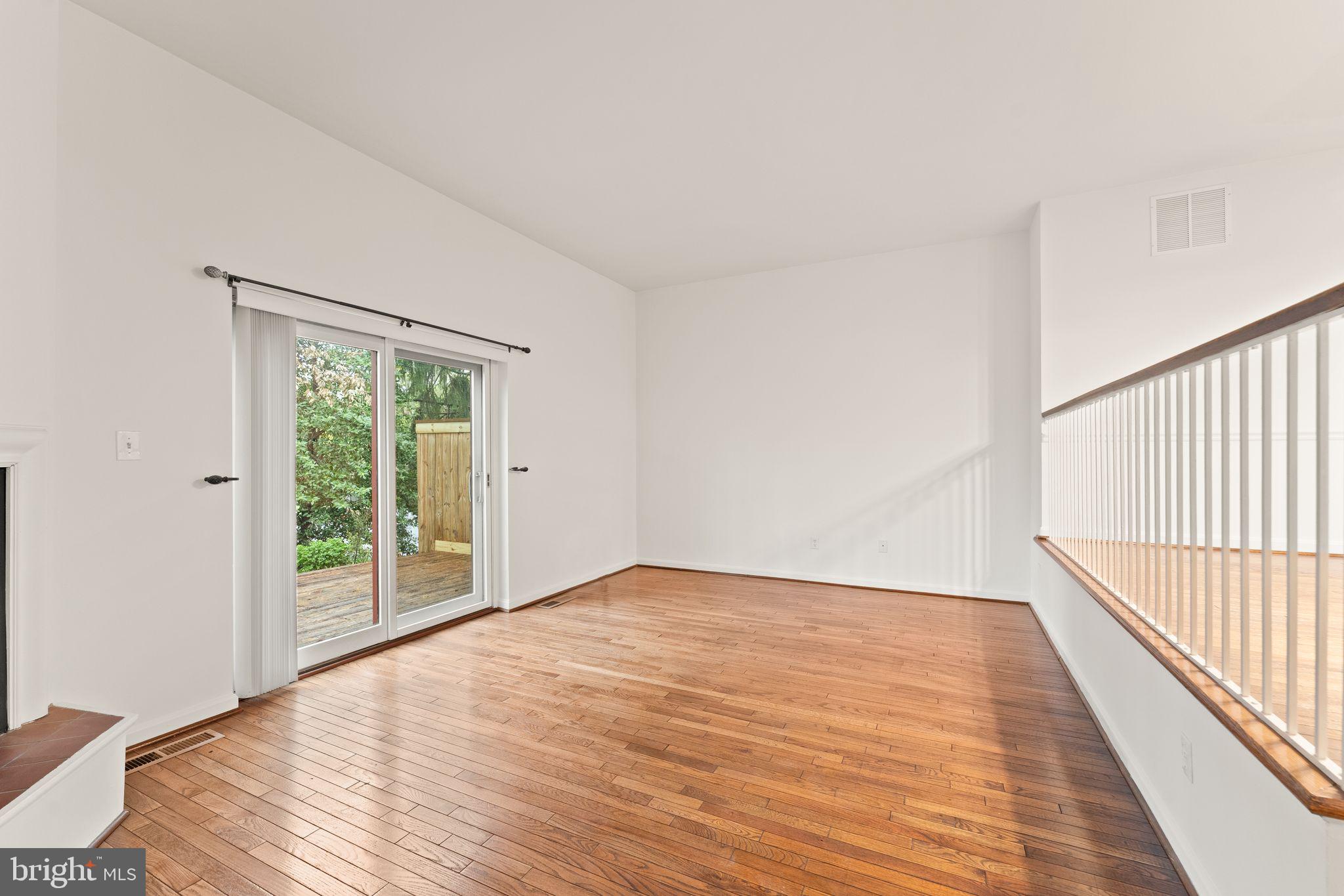 2212 Golf Course Drive Reston, VA 20191 - Photo 15 of 49 a view of an empty room with wooden floor and a window