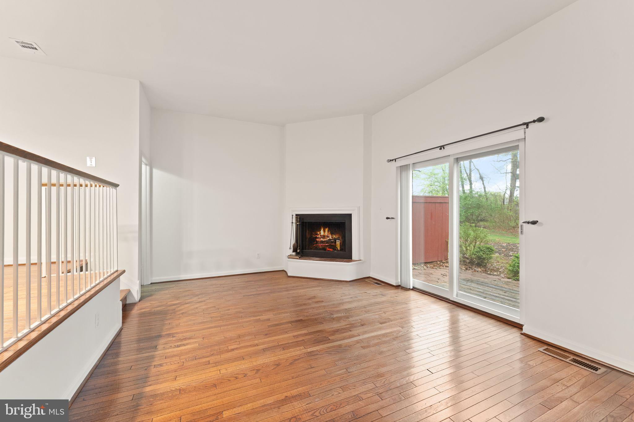 2212 Golf Course Drive Reston, VA 20191 - Photo 16 of 49 a view of an empty room with wooden floor and a window