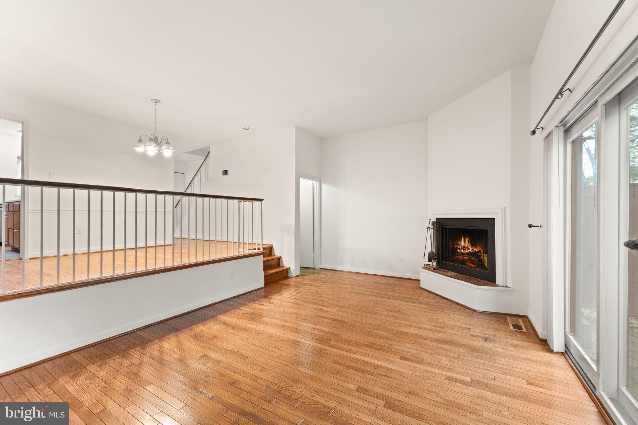 2212 Golf Course Drive Reston, VA 20191 - Photo 17 of 49 a view of a livingroom with wooden floor a fireplace and entryway