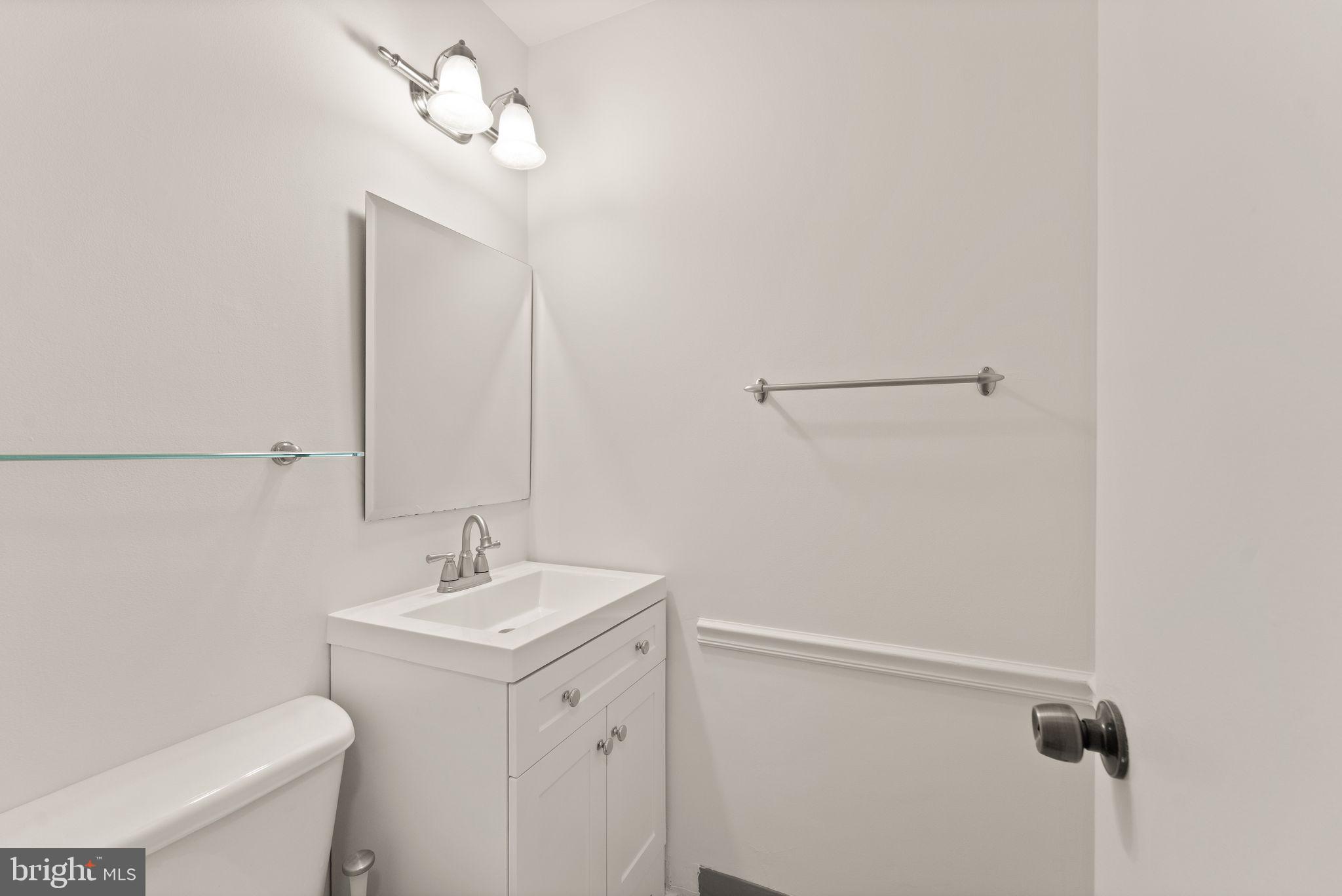 2212 Golf Course Drive Reston, VA 20191 - Photo 18 of 49 a bathroom with a sink a toilet and vanity
