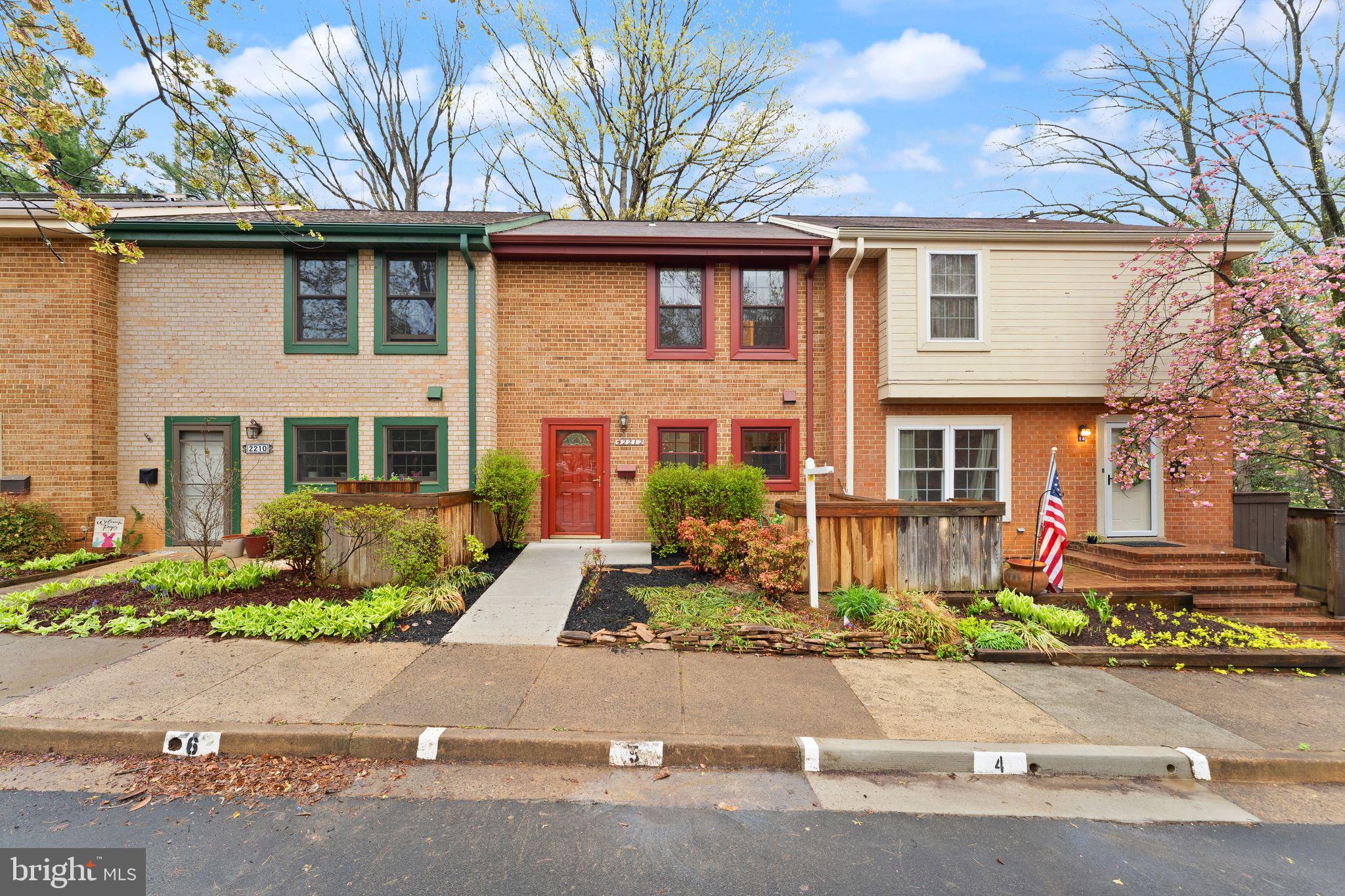 2212 Golf Course Drive Reston, VA 20191 - Photo 2 of 49 front view of a brick house with a yard