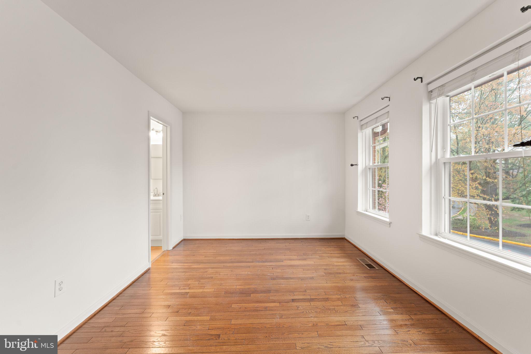 2212 Golf Course Drive Reston, VA 20191 - Photo 21 of 49 a view of an empty room with wooden floor and a window
