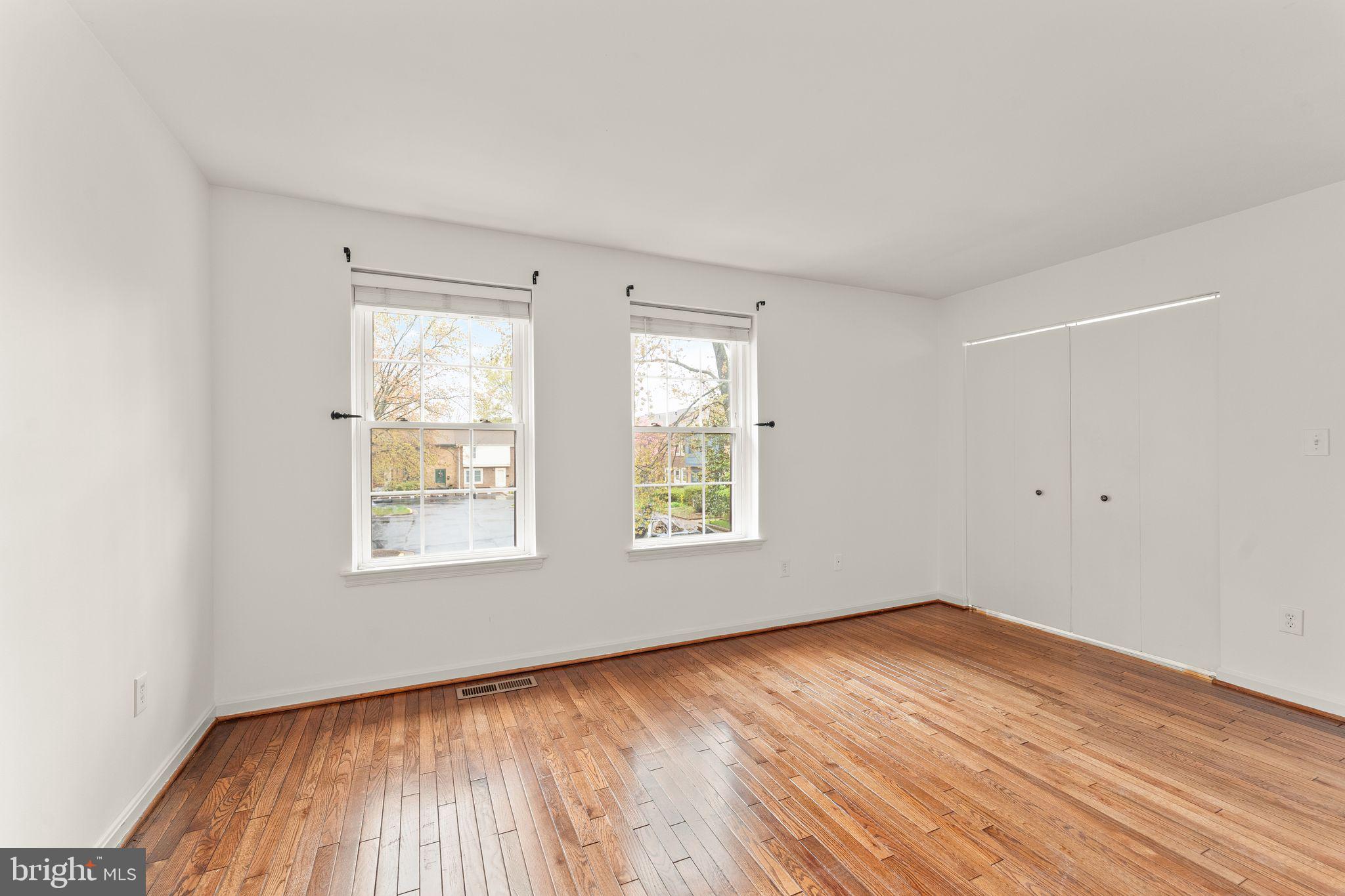 2212 Golf Course Drive Reston, VA 20191 - Photo 23 of 49 an empty room with wooden floor and windows