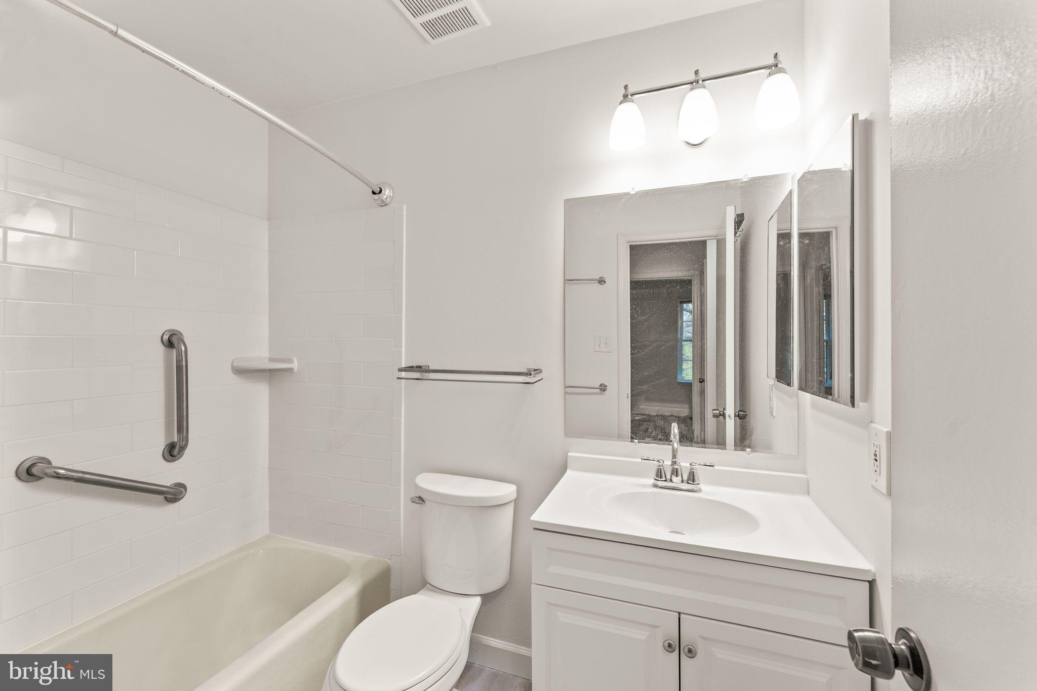 2212 Golf Course Drive Reston, VA 20191 - Photo 28 of 49 a bathroom with a sink toilet a mirror and shower