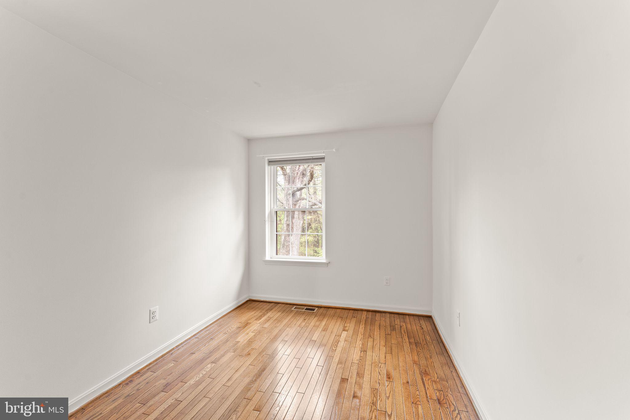 2212 Golf Course Drive Reston, VA 20191 - Photo 30 of 49 a view of an empty room with wooden floor and window