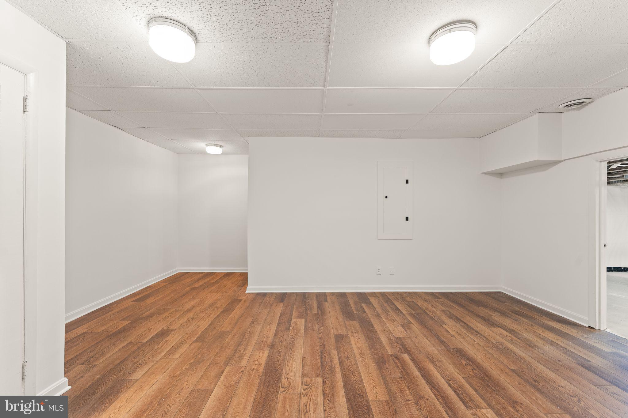 2212 Golf Course Drive Reston, VA 20191 - Photo 34 of 49 an empty room with wooden floor and white walls