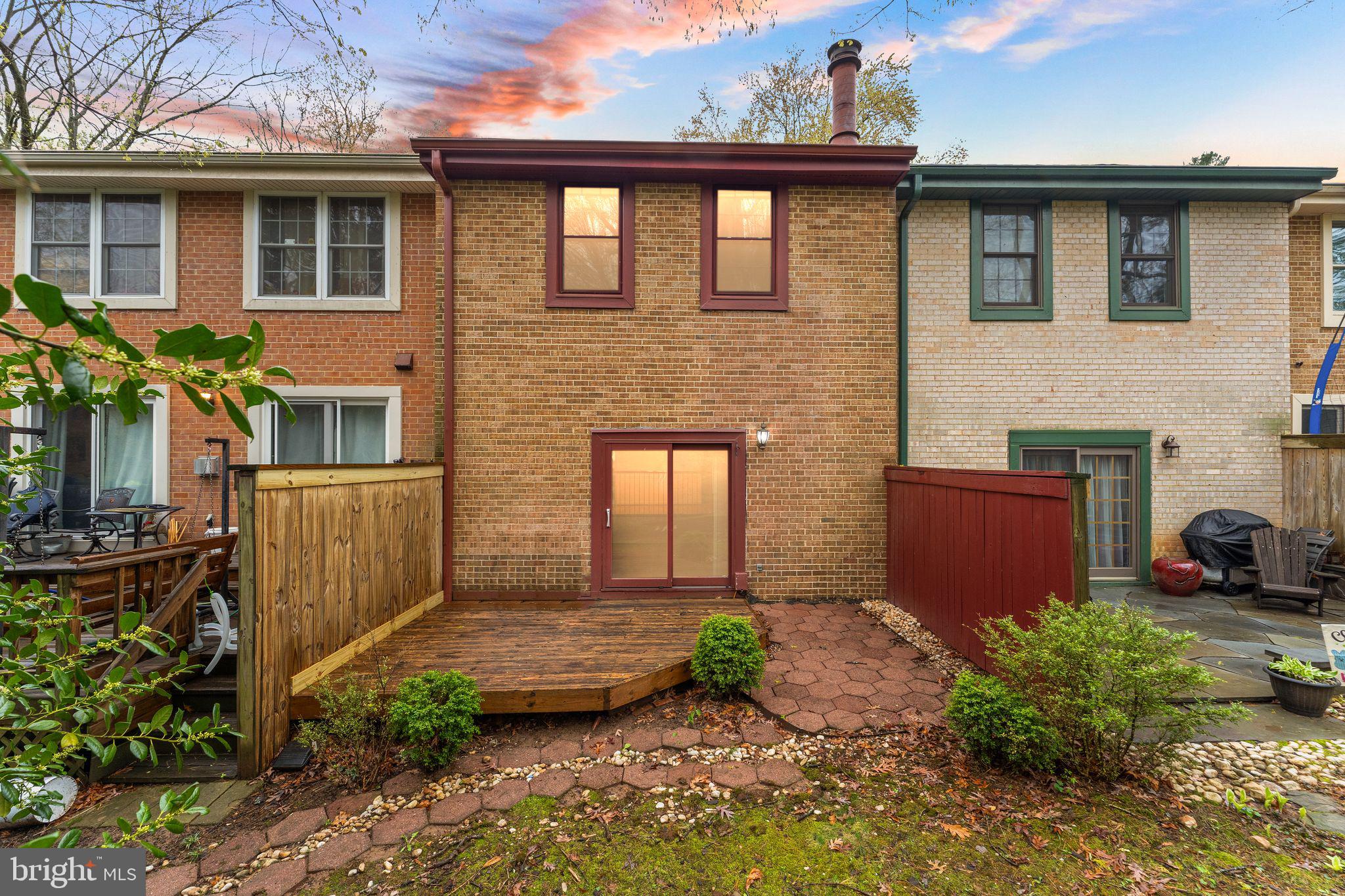 2212 Golf Course Drive Reston, VA 20191 - Photo 40 of 49 a front view of a house with a yard and potted plants