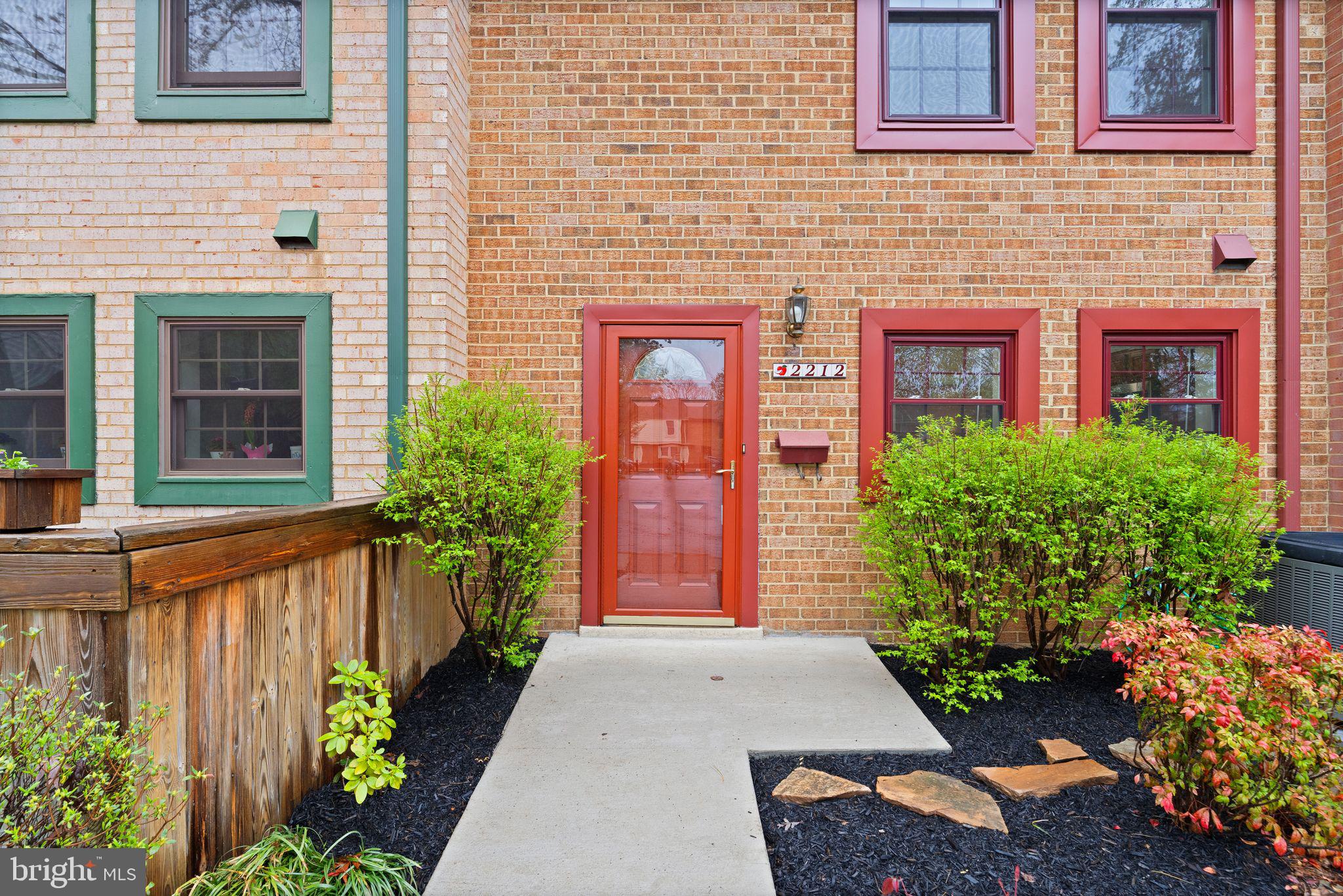 2212 Golf Course Drive Reston, VA 20191 - Photo 4 of 49 a front view of a house with a yard and flowers