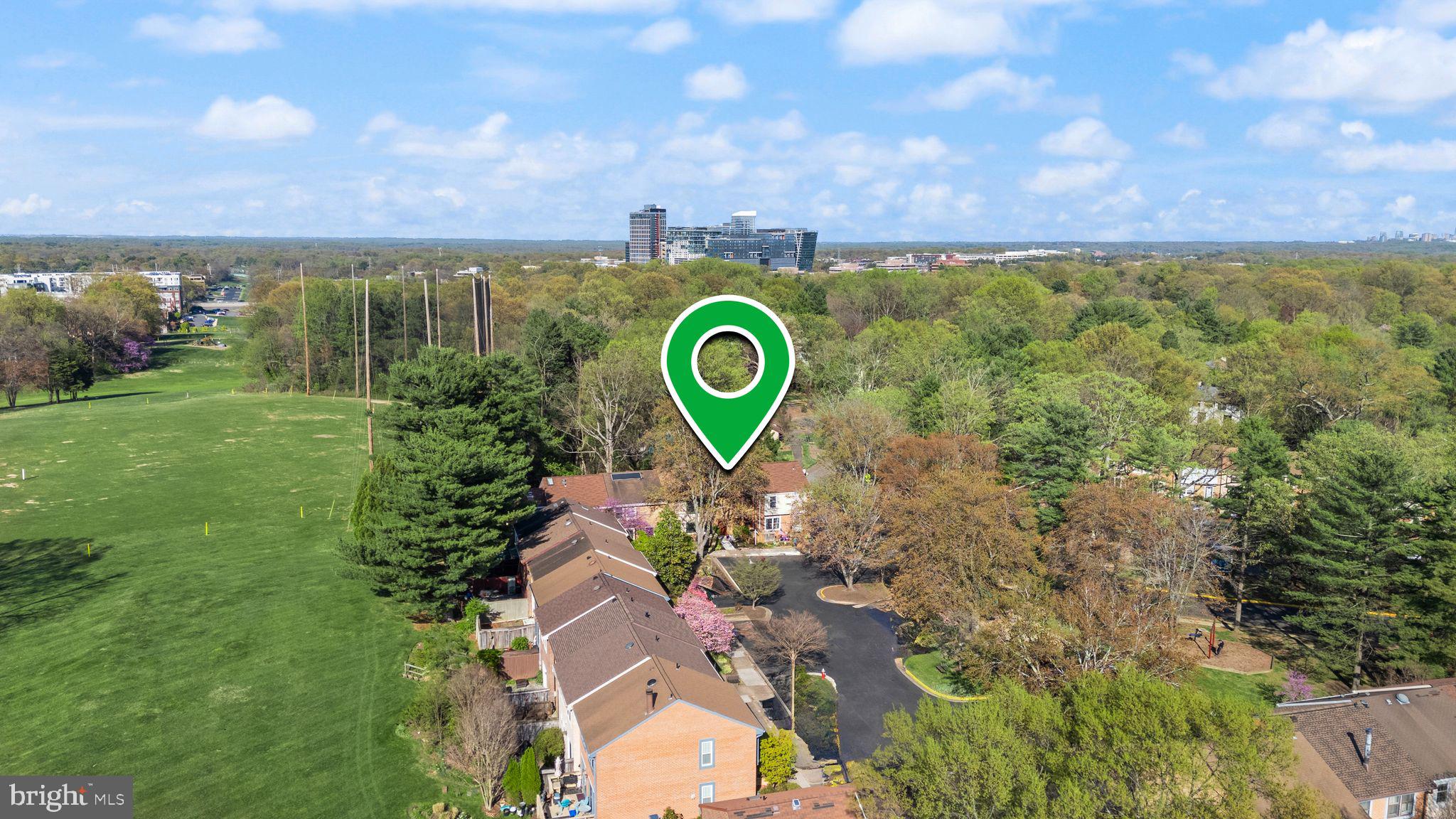2212 Golf Course Drive Reston, VA 20191 - Photo 48 of 49 a view of a garden with a building in the background