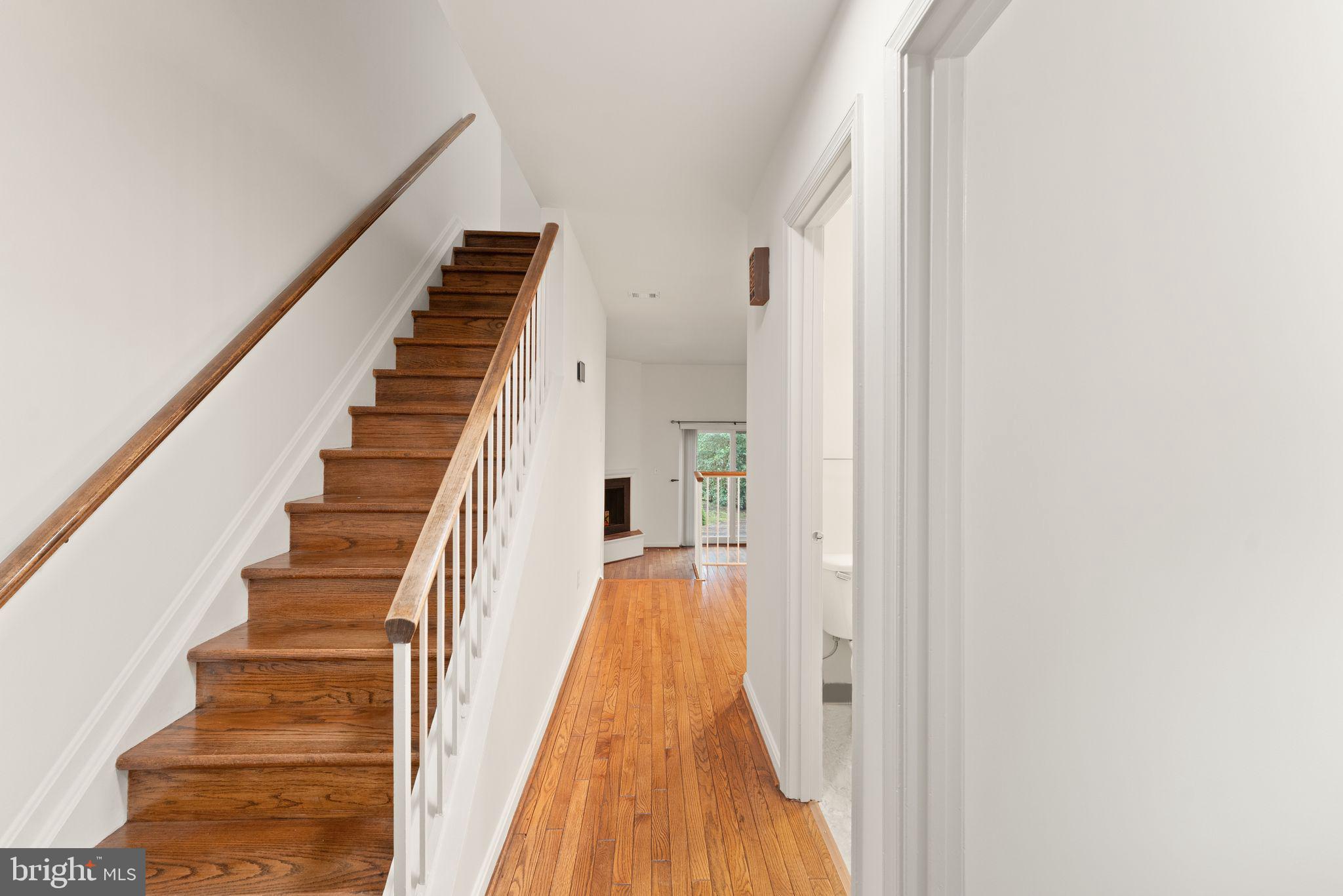 2212 Golf Course Drive Reston, VA 20191 - Photo 5 of 49 a view of a hallway with wooden floor and entryway