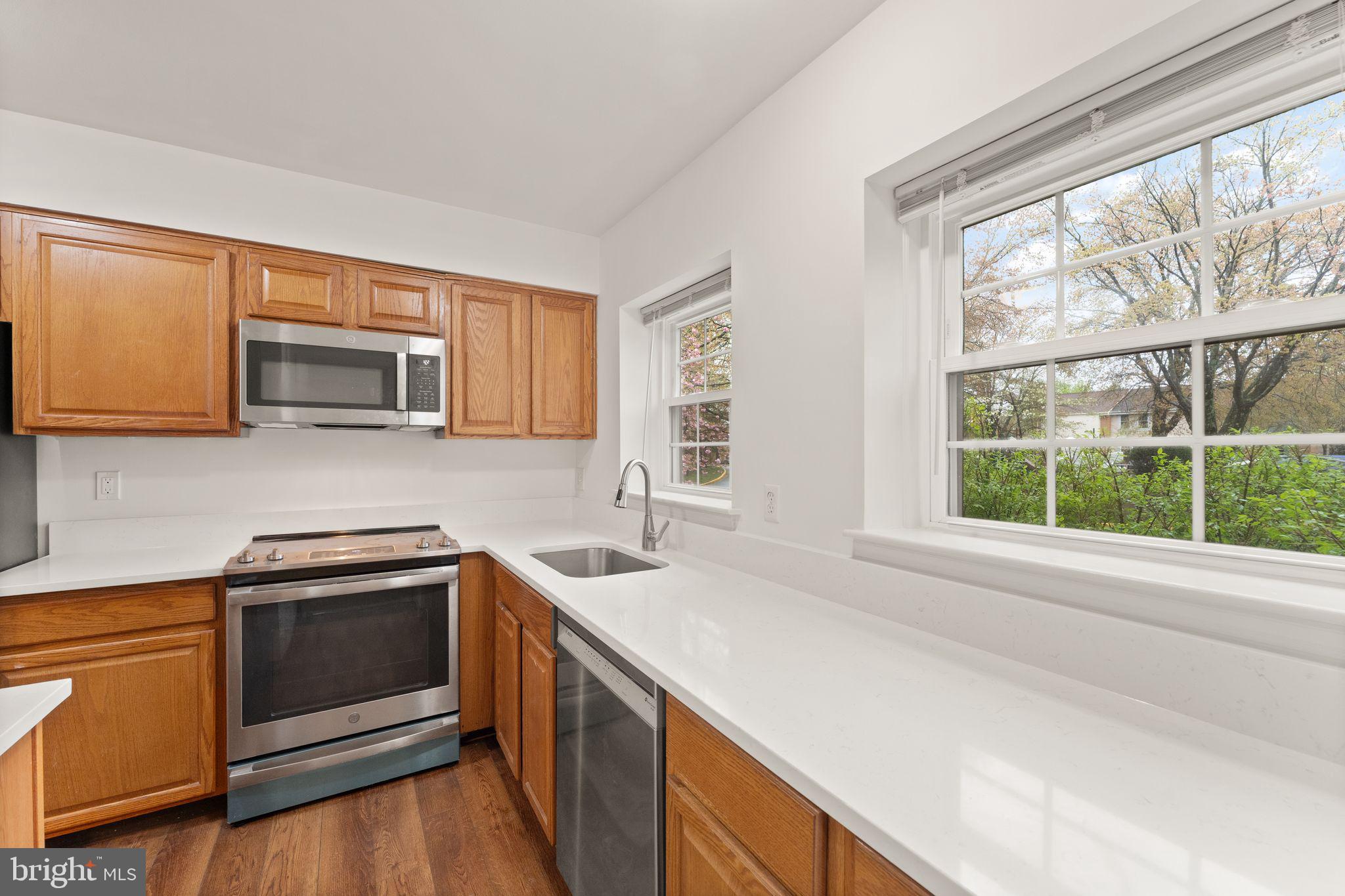 2212 Golf Course Drive Reston, VA 20191 - Photo 7 of 49 a kitchen with a sink stove and microwave