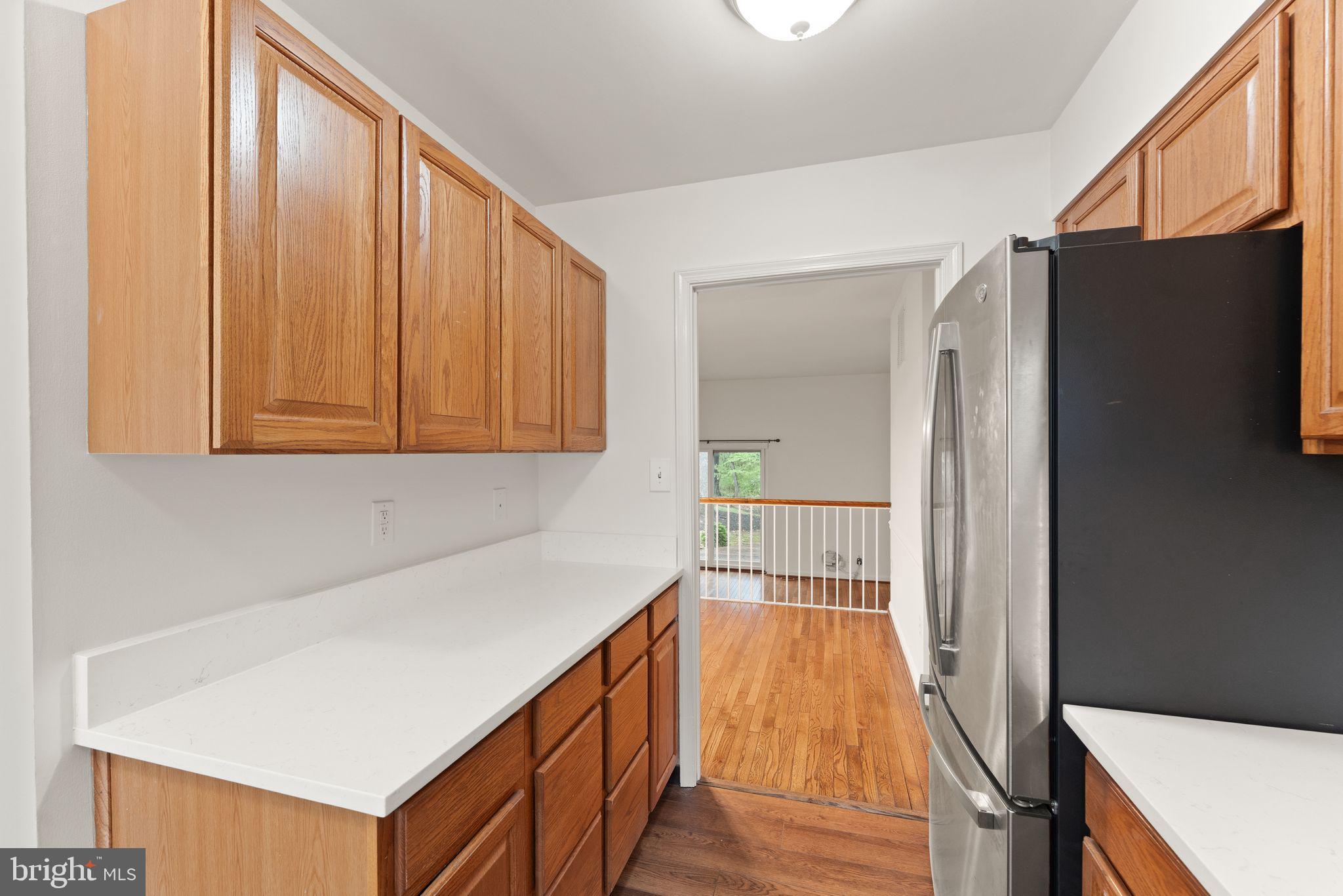 2212 Golf Course Drive Reston, VA 20191 - Photo 8 of 49 a view of a hallway with wooden floor and cabinet