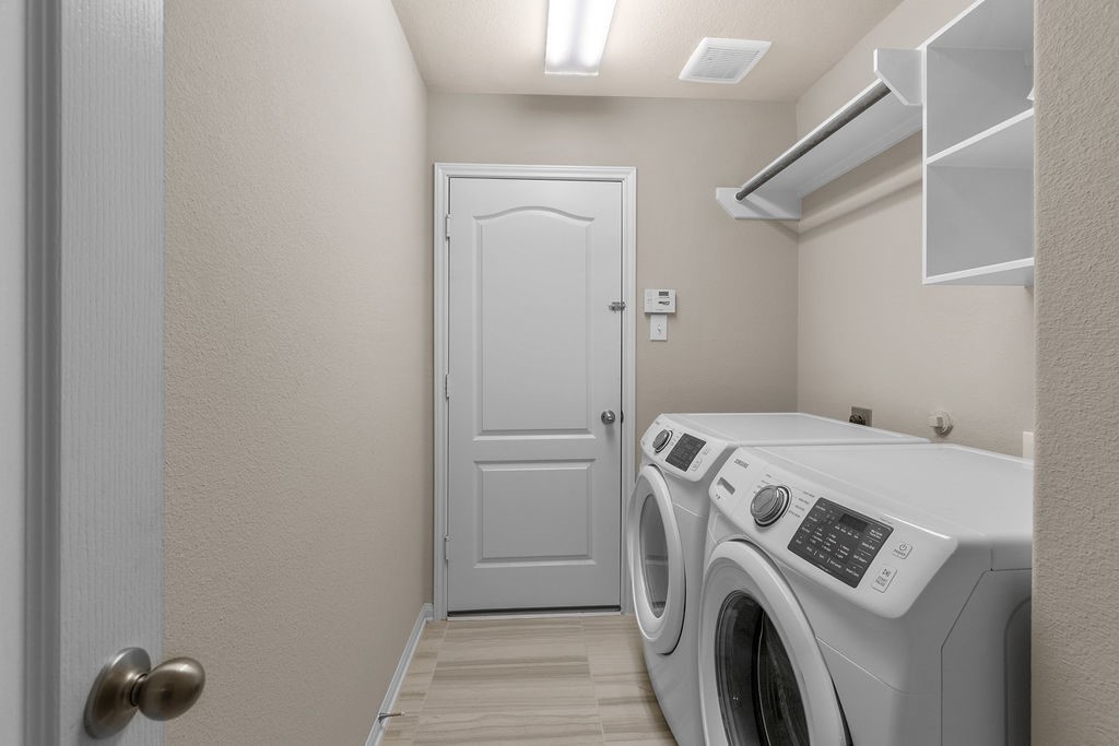 2666 Cedar Path Lane Conroe, TX 77385 - Photo 19 of 22 a view of storage and utility room with washer and dryer