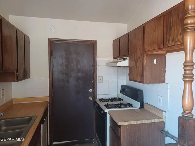 a kitchen with a stove and a refrigerator