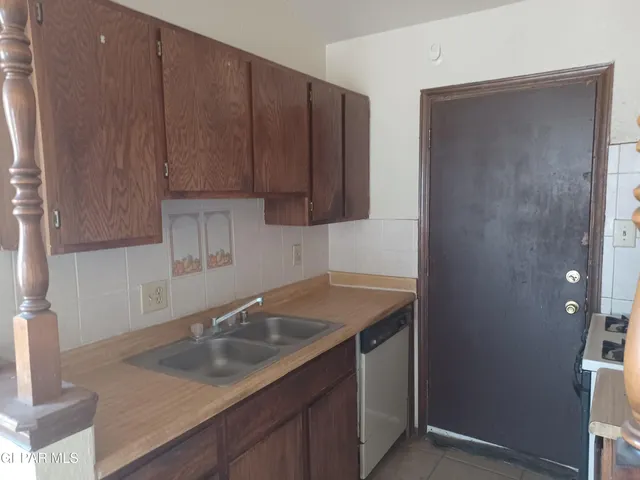 a kitchen with a sink cabinets and utility