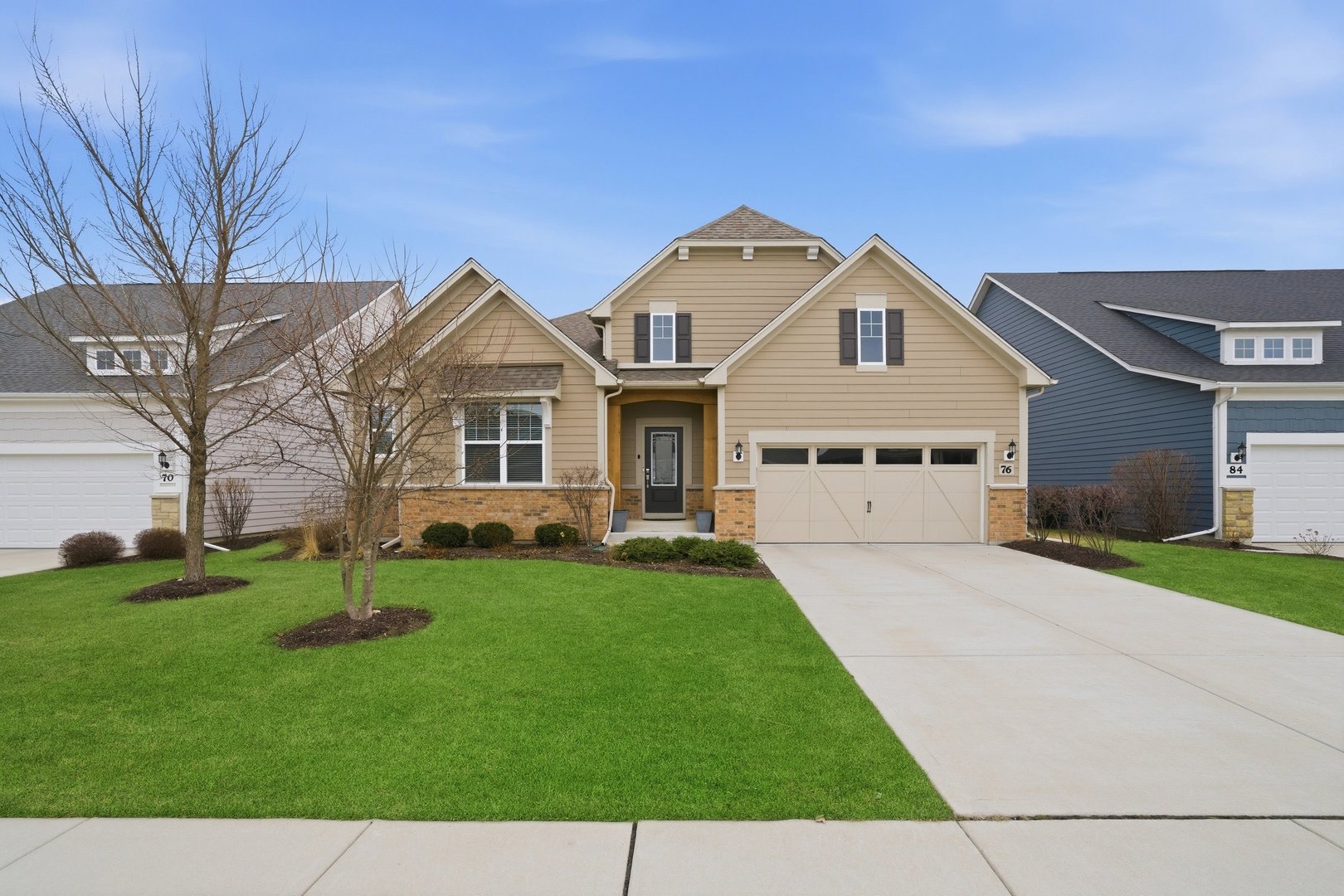 76 Somerset Circle Wheaton, IL 60189 - Photo 1 of 40 a front view of a house with a garden and trees
