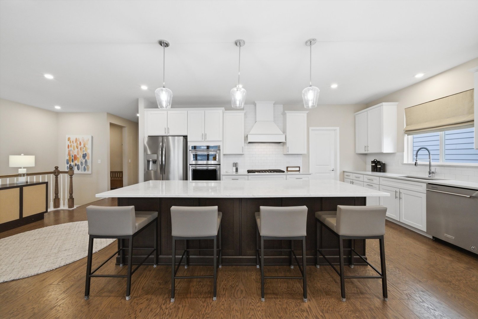 76 Somerset Circle Wheaton, IL 60189 - Photo 8 of 40 a kitchen with stainless steel appliances a dining table chairs refrigerator sink and cabinets