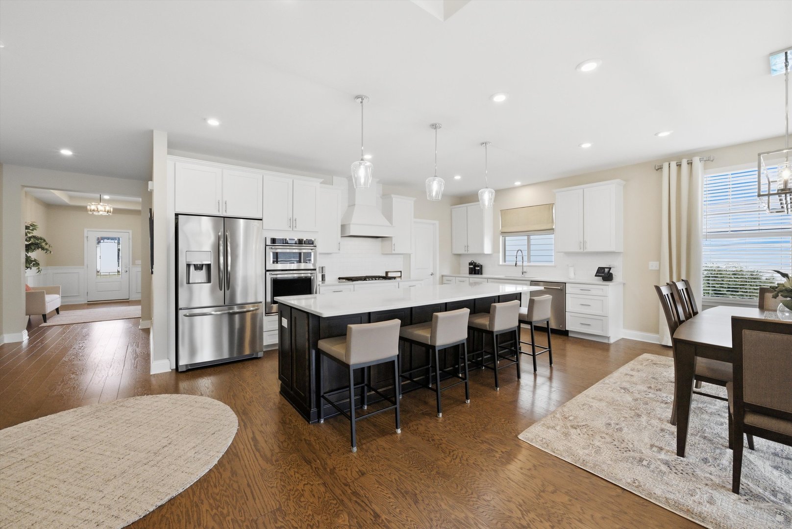 76 Somerset Circle Wheaton, IL 60189 - Photo 10 of 40 a large kitchen with stainless steel appliances refrigerator a dining table and chairs