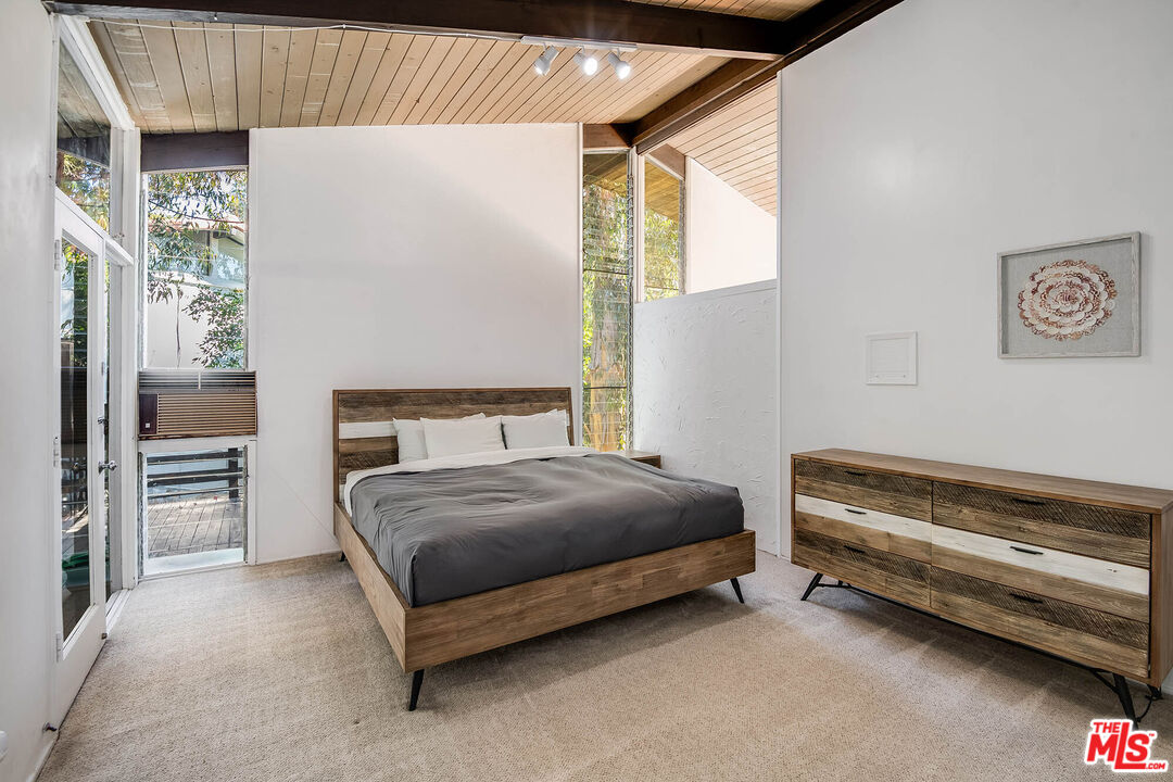 3557 Serra Road Malibu, CA 90265 - Photo 18 of 32 a bedroom with a bed and a window