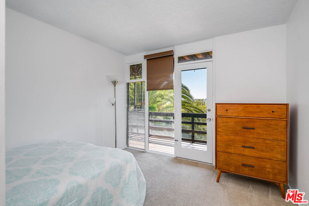 3557 Serra Road Malibu, CA 90265 - Photo 29 of 32 a bed room with a bed and a window