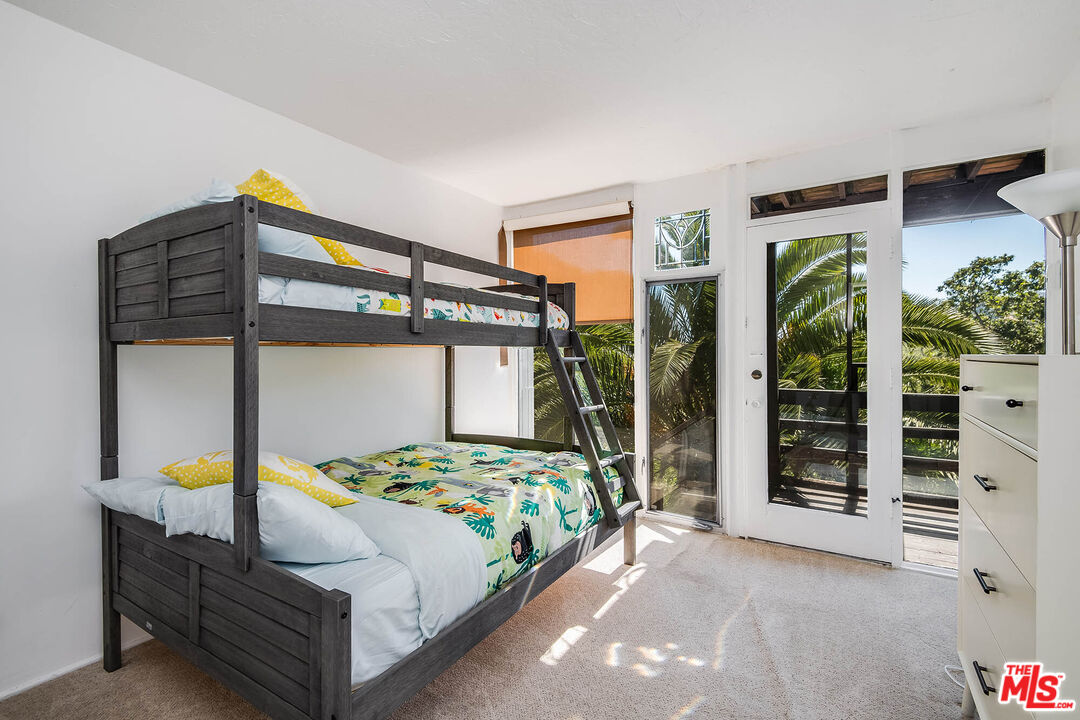 3557 Serra Road Malibu, CA 90265 - Photo 30 of 32 a bedroom with a bed next to a window