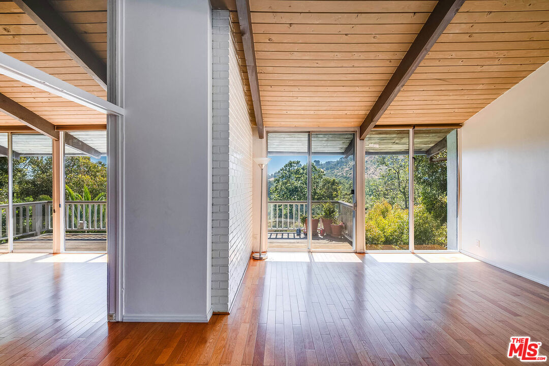 3557 Serra Road Malibu, CA 90265 - Photo 4 of 32 a view of room with wooden floor and balcony