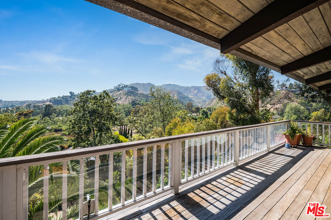 3557 Serra Road Malibu, CA 90265 - Photo 9 of 32 a view of a balcony with wooden floor