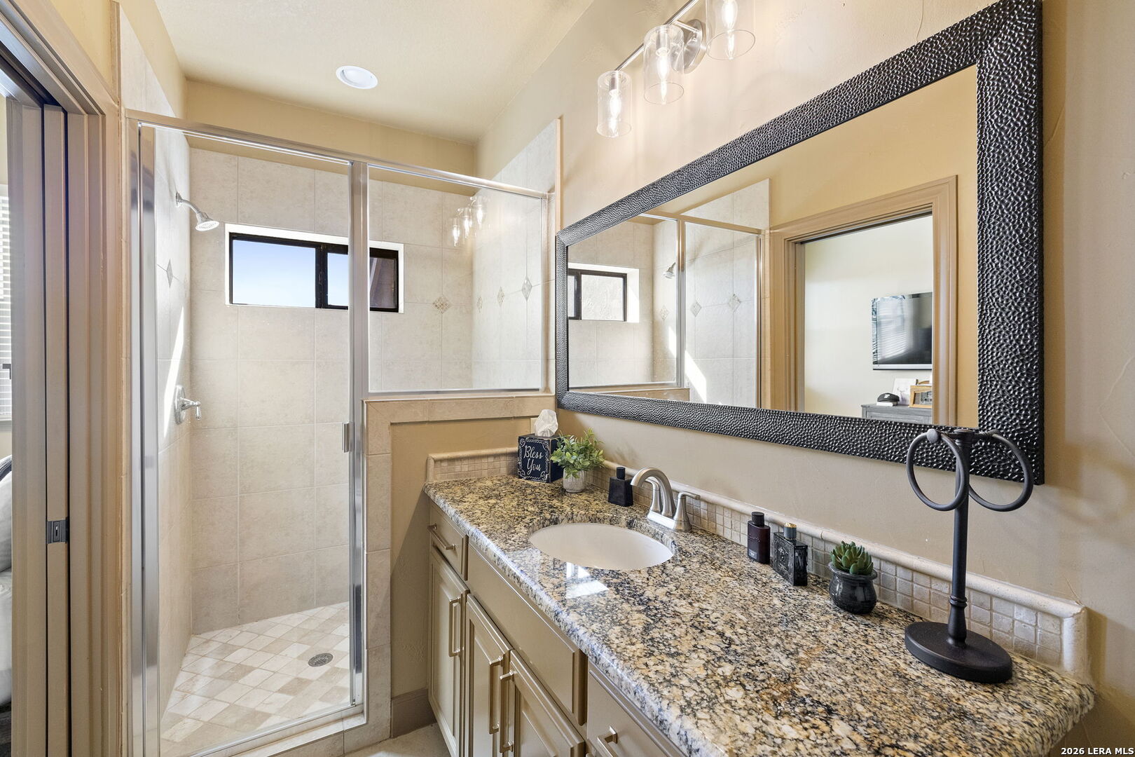 1941 Canyon Spring Branch, TX 78070 - Photo 38 of 86 a bathroom with a granite countertop sink a mirror and shower