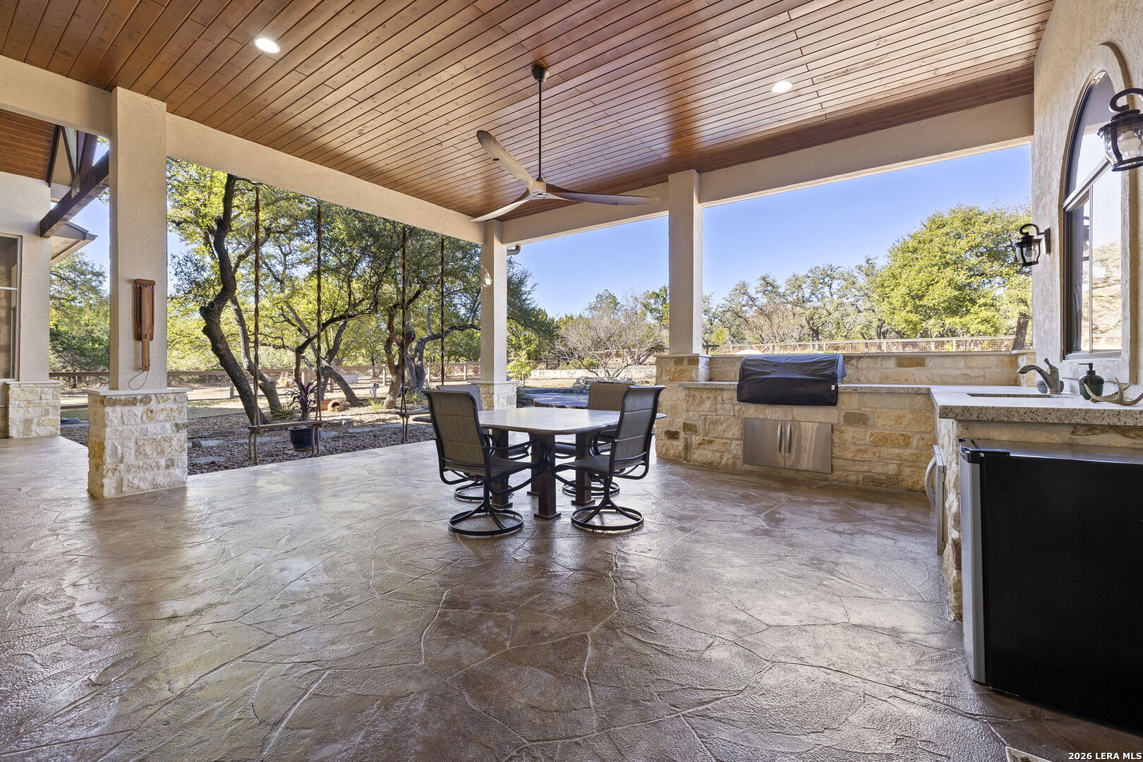 1941 Canyon Spring Branch, TX 78070 - Photo 53 of 86 a view of a patio with a table chairs and a floor to ceiling window