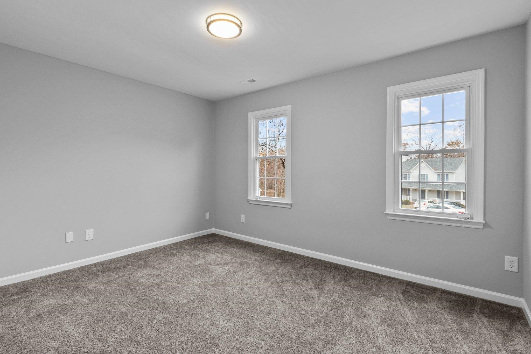5616 Torness Court Raleigh, NC 27604 - Photo 26 of 37 Bedroom 3 has carpet, standard closet, and two windows. Bedroom 3