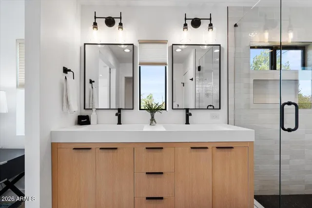 a bathroom with a double vanity sink and a mirror