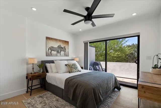 a bedroom with a large bed and a large window