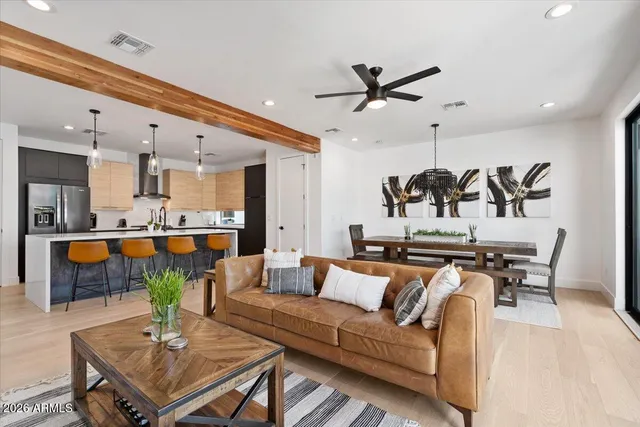 a living room with furniture a ceiling fan and a rug